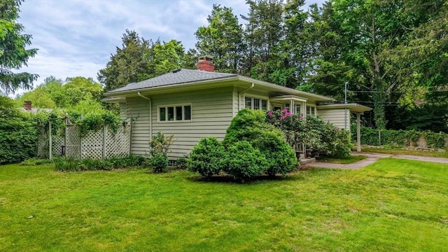 16 Stoneledge Rd, Dartmouth, MA 02748 - view of property exterior featuring a lawn and a chimney