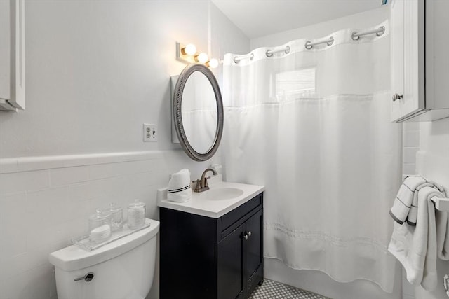 full bathroom with vanity, tile walls, shower / tub combo, and toilet