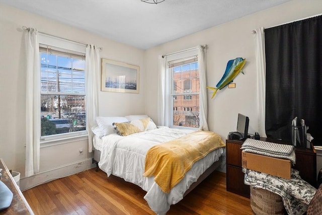 bedroom with dark wood-type flooring