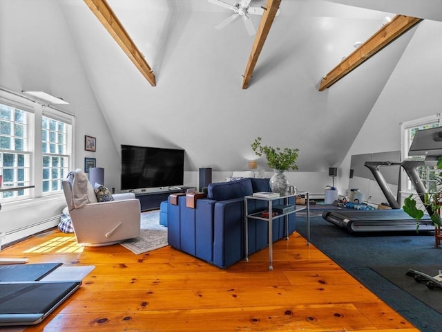 living area featuring a ceiling fan, a baseboard heating unit, vaulted ceiling with beams, and hardwood / wood-style floors