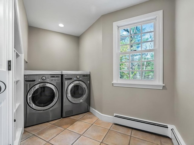 laundry room with laundry area, light tile patterned flooring, baseboards, baseboard heating, and separate washer and dryer
