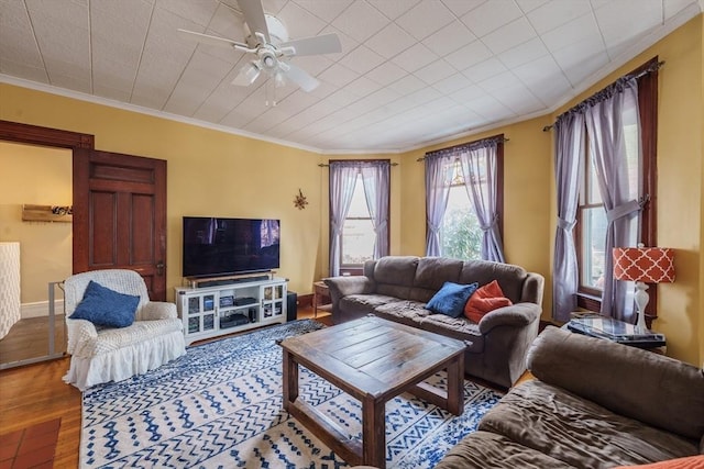 living room featuring crown molding, hardwood / wood-style floors, and ceiling fan