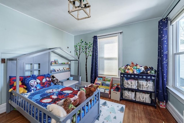 bedroom featuring ornamental molding and dark hardwood / wood-style floors