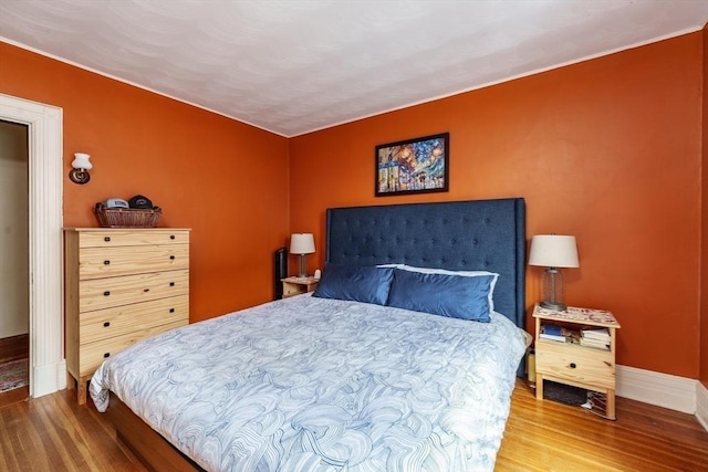 bedroom with hardwood / wood-style flooring