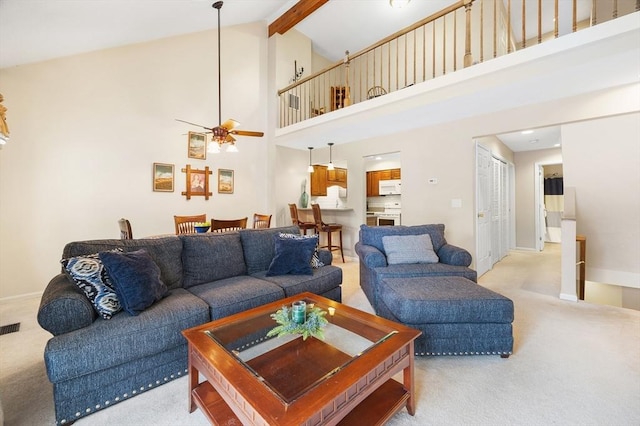 carpeted living room featuring ceiling fan, beam ceiling, and high vaulted ceiling