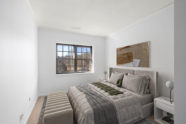 bedroom with ornamental molding, carpet, visible vents, and baseboards