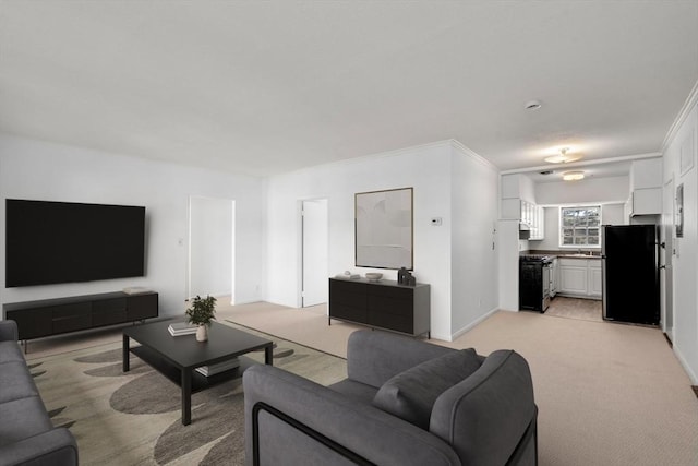 living room with light carpet, ornamental molding, and baseboards