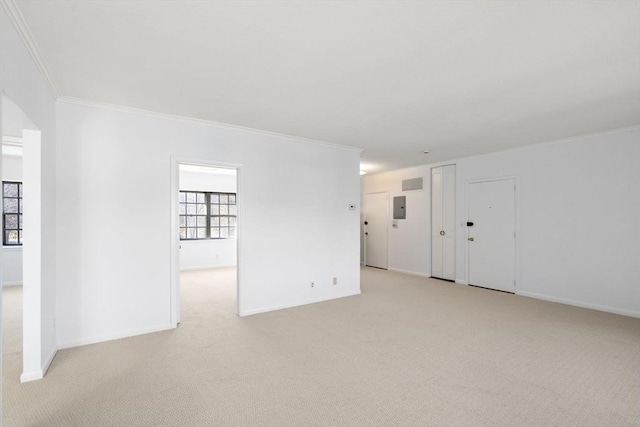 unfurnished room featuring light carpet, baseboards, electric panel, and crown molding