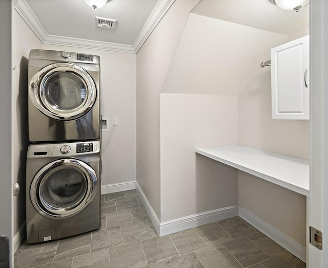 laundry room with stacked washing machine and dryer, baseboards, and crown molding
