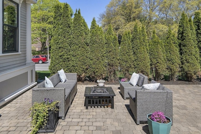 view of patio / terrace with an outdoor living space with a fire pit