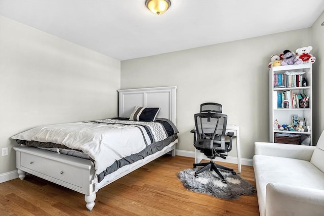 3 Lowell St Unit 1, Waltham, MA 02453 - bedroom featuring wood finished floors, baseboards, and a desk