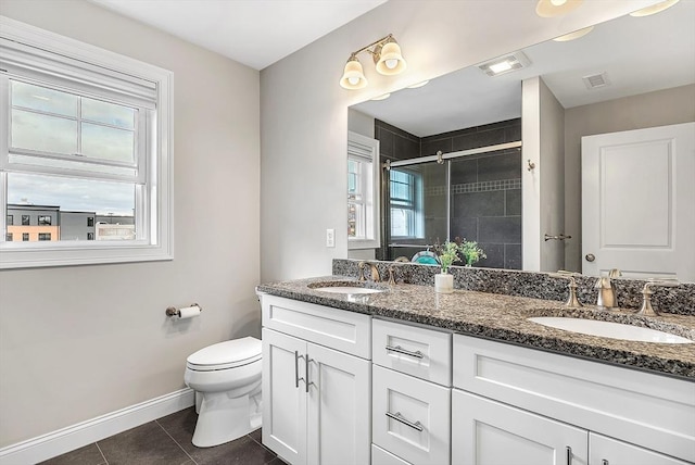 3 Lowell St Unit 1, Waltham, MA 02453 - bathroom with double vanity, a shower stall, tile patterned floors, baseboards, and toilet