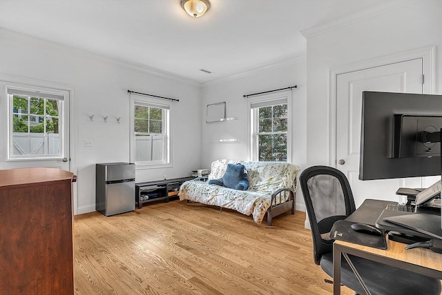 3 Lowell St Unit 1, Waltham, MA 02453 - home office featuring crown molding, plenty of natural light, light wood-type flooring, and baseboards