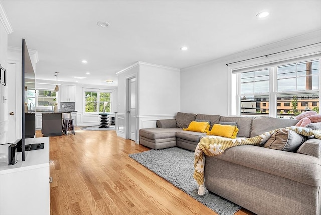 3 Lowell St Unit 1, Waltham, MA 02453 - living area featuring crown molding, light wood finished floors, recessed lighting, and wainscoting