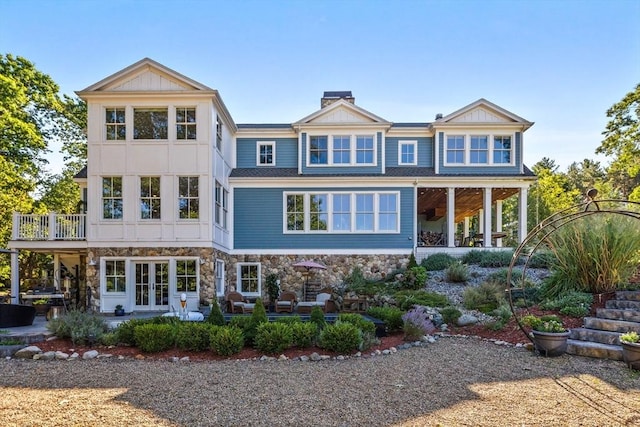 14 Reiling Pond Rd, Lincoln, MA 01773 - view of front of house with a patio area, stone siding, and french doors