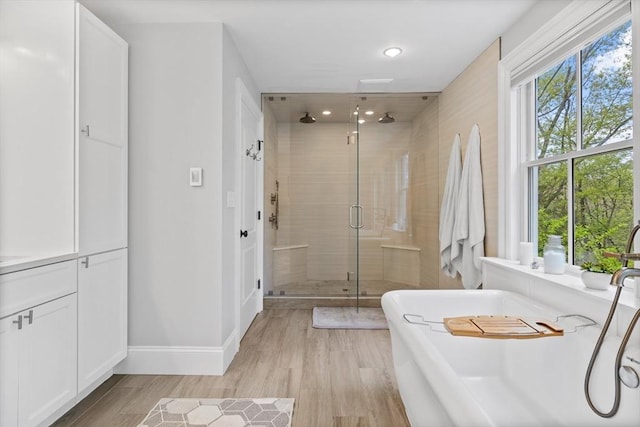 14 Reiling Pond Rd, Lincoln, MA 01773 - full bathroom featuring a shower stall, a soaking tub, wood finished floors, and recessed lighting