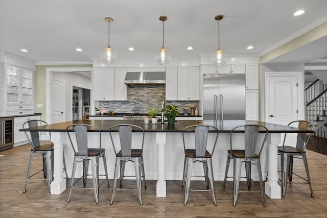14 Reiling Pond Rd, Lincoln, MA 01773 - kitchen featuring stainless steel built in fridge, wall chimney exhaust hood, dark countertops, wine cooler, and white cabinetry