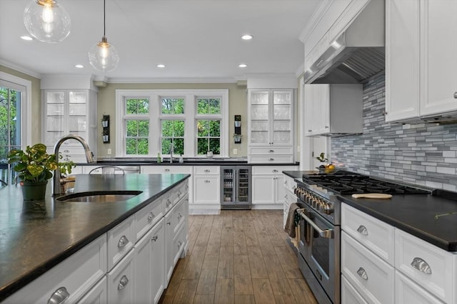 14 Reiling Pond Rd, Lincoln, MA 01773 - kitchen with double oven range, beverage cooler, dark countertops, wall chimney exhaust hood, and ornamental molding