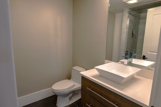 bathroom with vanity, a shower with shower door, toilet, and tile patterned flooring