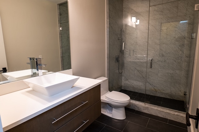 bathroom featuring walk in shower, vanity, tile patterned flooring, and toilet