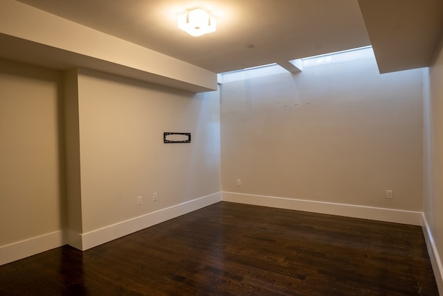 basement featuring dark hardwood / wood-style flooring