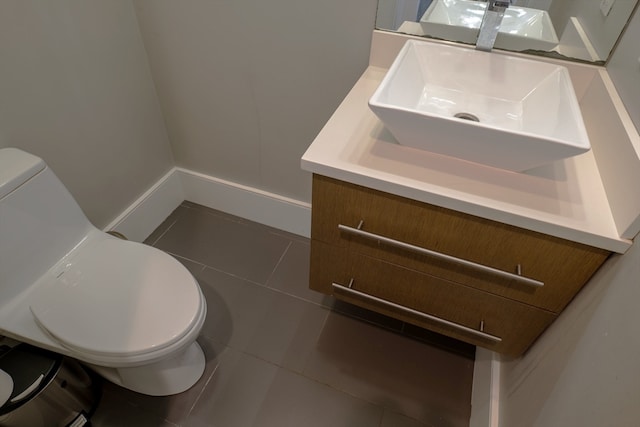 bathroom with tile patterned flooring, vanity, and toilet