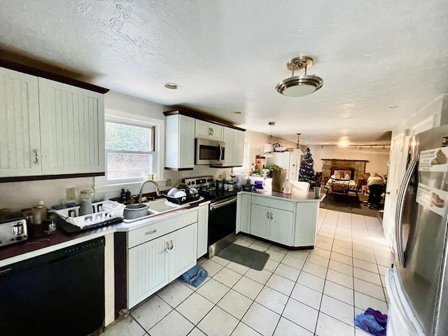 48 Grove, Plympton, MA 02367 - kitchen with stainless steel appliances, a peninsula, a sink, open floor plan, and light tile patterned flooring