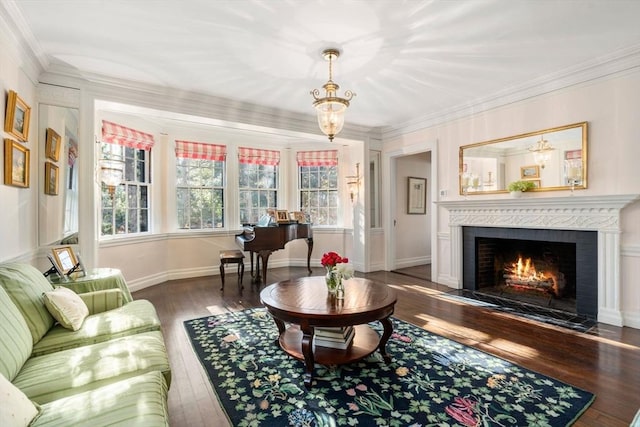 interior space featuring a chandelier, a fireplace with flush hearth, wood finished floors, baseboards, and ornamental molding