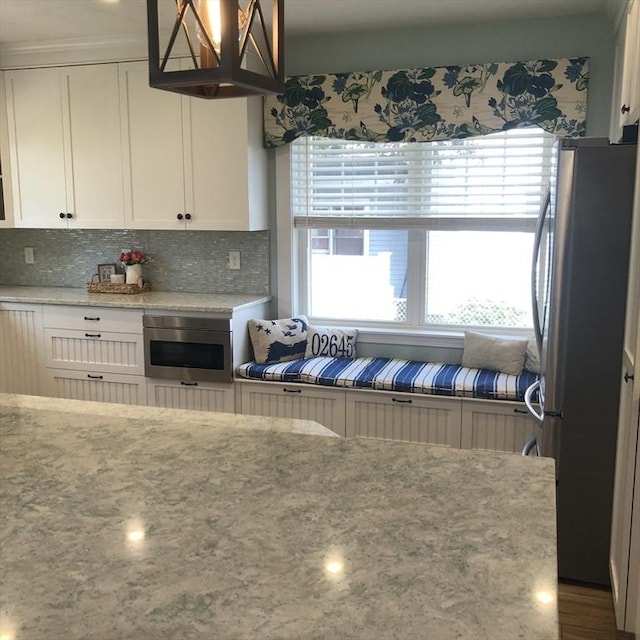 14 Highland St, Clinton, MA 01510 - kitchen featuring appliances with stainless steel finishes, white cabinetry, decorative backsplash, and light stone counters