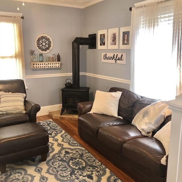 14 Highland St, Clinton, MA 01510 - living area with a wood stove, crown molding, and wood finished floors