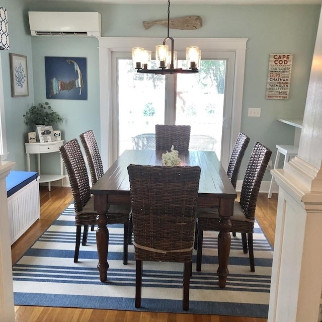 14 Highland St, Clinton, MA 01510 - dining space with a wall unit AC, a chandelier, wood finished floors, and plenty of natural light