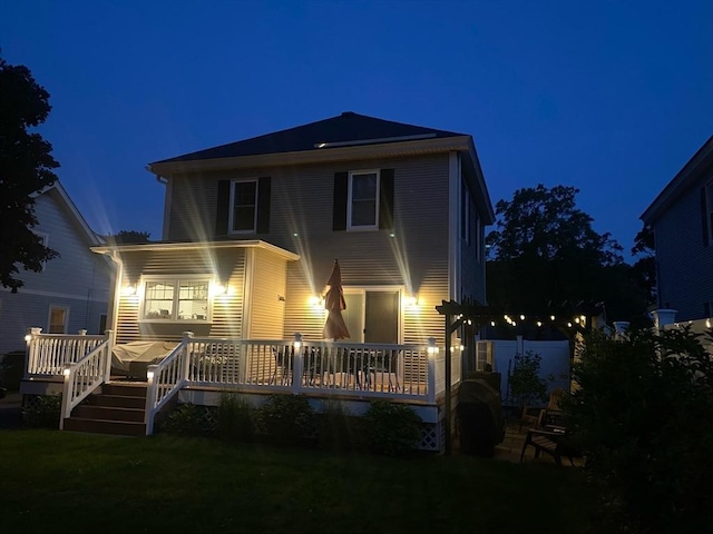 14 Highland St, Clinton, MA 01510 - back of house at twilight featuring a wooden deck and a yard