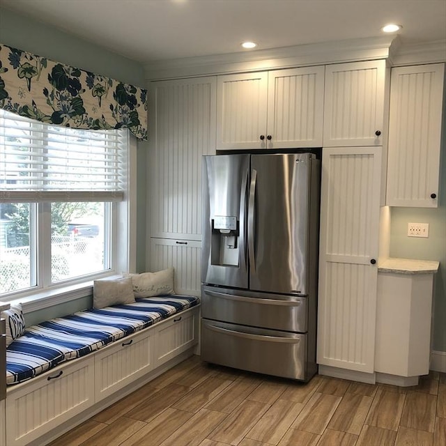 14 Highland St, Clinton, MA 01510 - kitchen with stainless steel fridge, light wood-type flooring, light countertops, recessed lighting, and white cabinetry