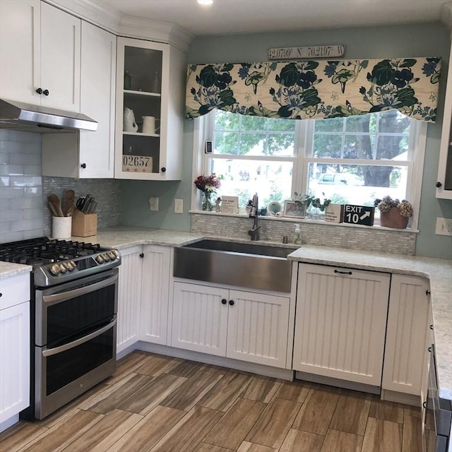 14 Highland St, Clinton, MA 01510 - kitchen with double oven range, under cabinet range hood, wood finish floors, and backsplash