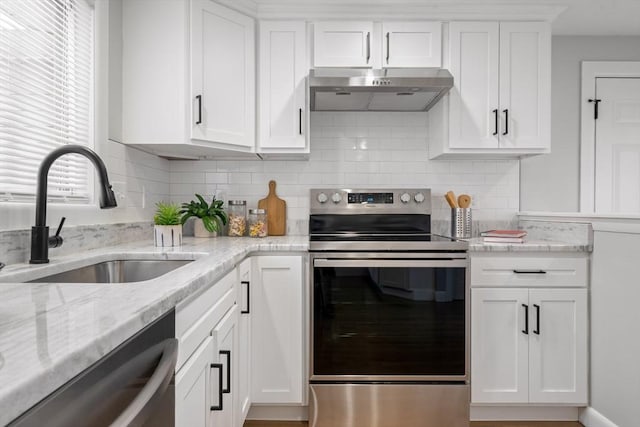 kitchen featuring stainless steel range with electric stovetop, sink, and white cabinetry