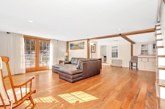 living area featuring french doors, recessed lighting, radiator, stairway, and light wood-style floors