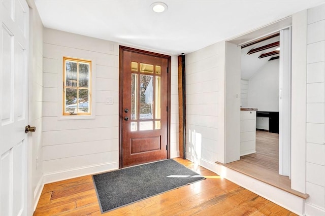 foyer featuring baseboards and hardwood / wood-style floors