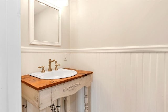 bathroom with wainscoting and a sink