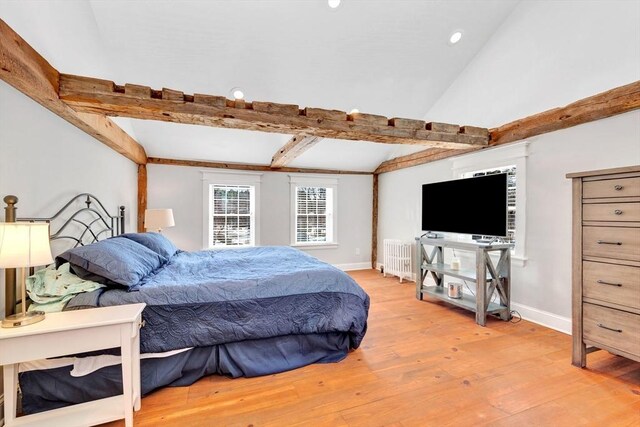 bedroom with recessed lighting, radiator, lofted ceiling with beams, wood finished floors, and baseboards