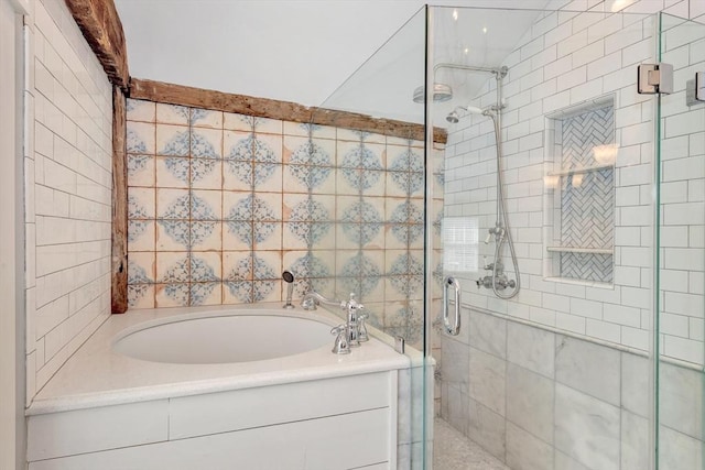 bathroom with a stall shower, a bath, and tile walls