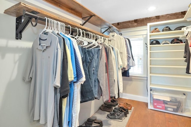 walk in closet featuring wood finished floors