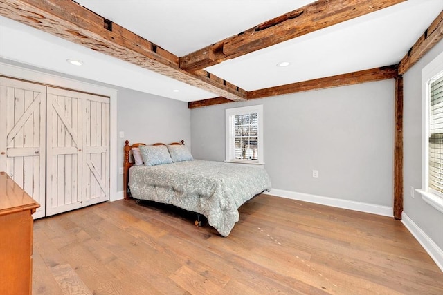 bedroom with recessed lighting, baseboards, beam ceiling, and wood finished floors