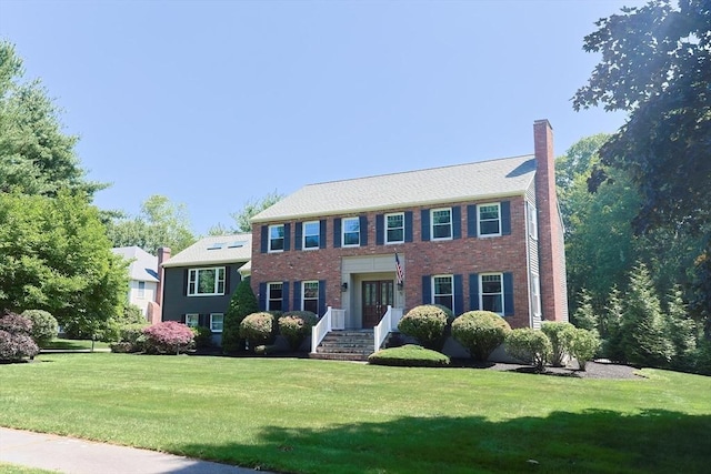 5 Windsor Rd, Lynnfield, MA 01940 - colonial inspired home featuring a front lawn, a chimney, brick siding, and french doors