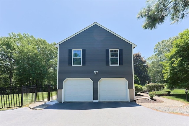 5 Windsor Rd, Lynnfield, MA 01940 - view of side of home with an attached garage and asphalt driveway