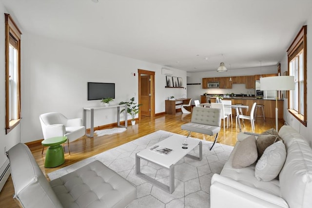 432 Norfolk St Unit 3B, Somerville, MA 02143 - living area with light wood-style flooring and a baseboard radiator