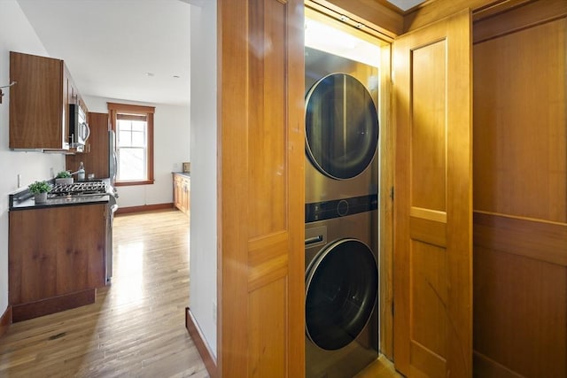432 Norfolk St Unit 3B, Somerville, MA 02143 - laundry room featuring stacked washing machine and dryer and light wood-type flooring