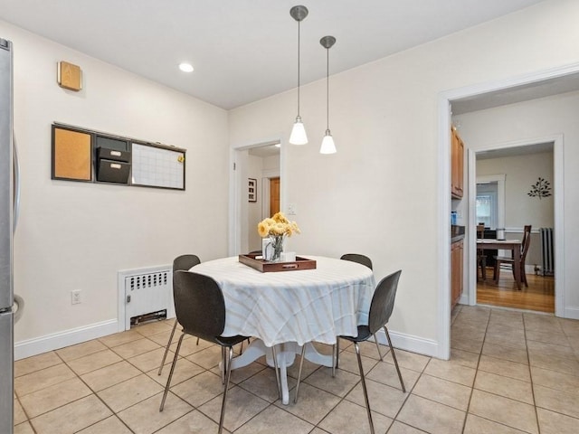 tiled dining room featuring radiator heating unit