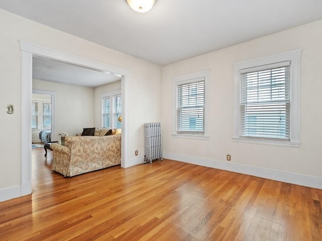 sitting room featuring radiator and light wood-type flooring