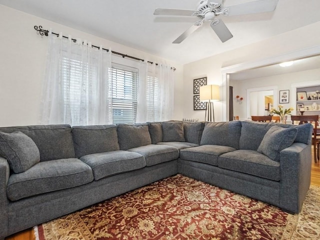 living room with ceiling fan and wood-type flooring