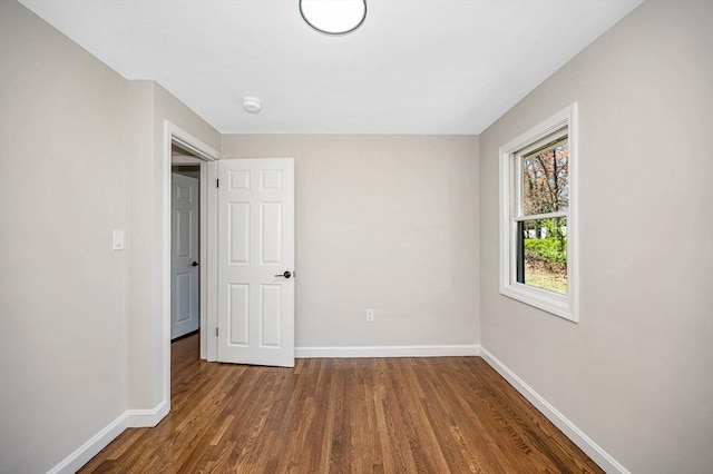 unfurnished bedroom featuring baseboards and wood finished floors